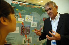 The group leader of the Safety, Environment and Health group, Jean Philippe Girard, explaining ITER safety systems to a participant of the IAEA conference.
