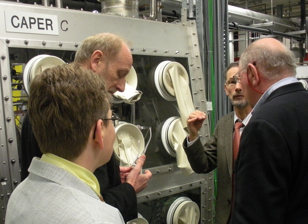 Lothar Dörr (centre), Head of the Tritium Lab, explains the tritium fuel cycle and the principle of the glove boxes to Neil Calder, Head of ITER Communication Office (right). Beate Bornschein, Deputy Head of TLK, and Manfred Glugla, ITER Tritium Plant Division Leader listen in. The CAPER experiment comprises a torus mockup section to produce the tritiated gases resulting from the operation of ITER.