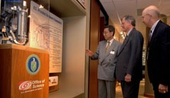 Kaname Ikeda views a display of components that the U.S. Office will provide for ITER. Looking on are U.S. ITER Project Manager Ned Sauthoff (center) and Deputy Project Manager Carl Strawbridge. (U.S. Department of Energy, Photo by Lynn Freeny).