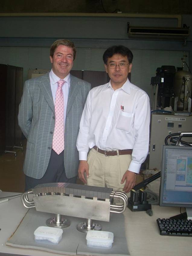 Mario Merola (left) and Satoshi Suzuki (right) posing behind the Japanese vertical target qualification prototype. (Click to view larger version...)